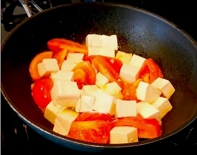 Spicy tofu with tomatoes and chilies, an aromatic, nutritious vegan dish with Ayurvedic flavors and healthy ingredients.